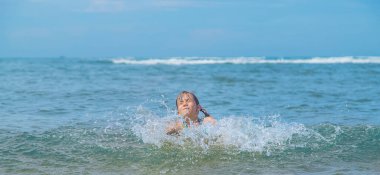 A child drowns in water at sea. Selective focus.