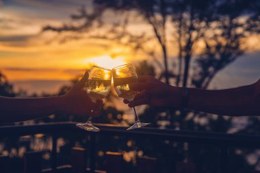 Gün batımında bir kadeh şarapla. Seçici odak.