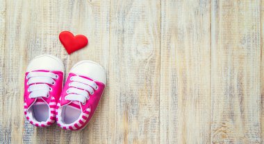 Hafif arka planda bebek poposu ve kalp. Seçici odak.