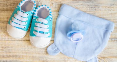 Baby clothes and accessories on a light background. Selective focus.