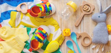 Baby clothes and accessories on a light background. Selective focus.