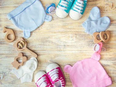 Baby clothes and accessories on a light background. Selective focus.