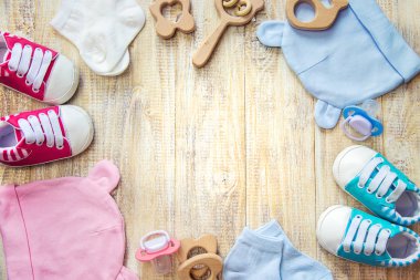 Baby clothes and accessories on a light background. Selective focus.