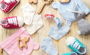 Baby clothes and accessories on a light background. Selective focus.
