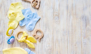 Baby clothes and accessories on a light background. Selective focus.