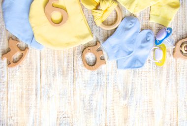 Baby clothes and accessories on a light background. Selective focus.