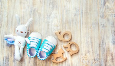 Baby clothes and accessories on a light background. Selective focus.
