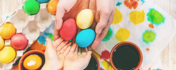 family paints easter eggs. Selective focus. celebration hilidays