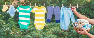 washing baby clothes. Linen dries in the fresh air. Selective focus. nature. clipart