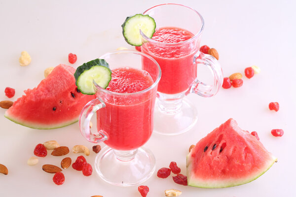 watermelon smoothie with cucumber and nuts on white background