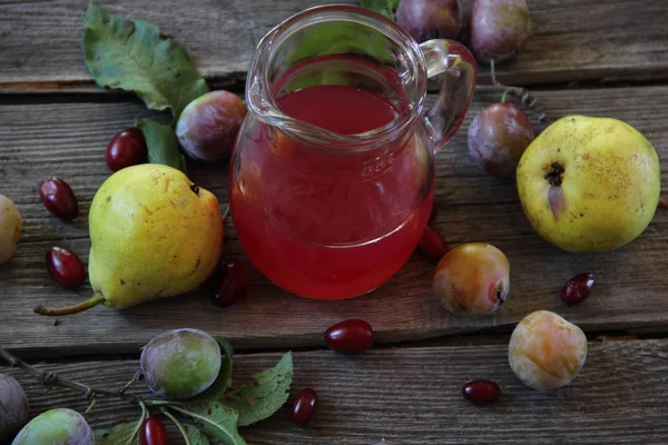 Compote of pears and plums in a glass jar — Stock Photo, Image