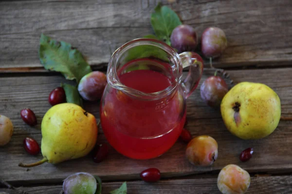 Compote of pears and plums in a glass jar — Stock Photo, Image