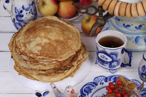 Pancakes are stacked on a plate on a festive table — Stock Photo, Image