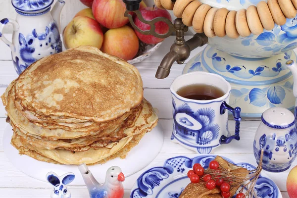 Pancakes are stacked on a plate on a festive table — Stock Photo, Image