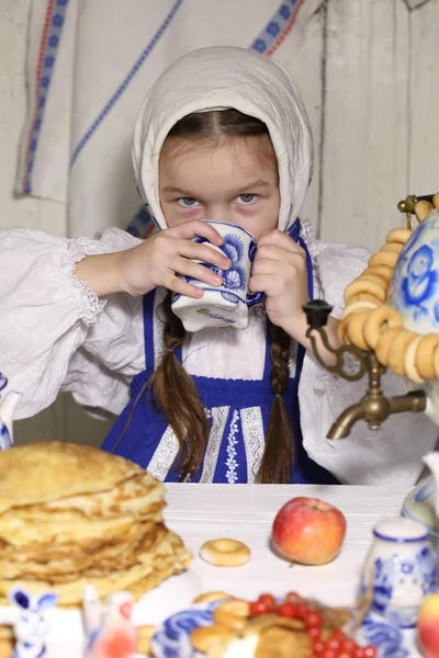 Girl drinking tea at the holiday table — Stock Photo, Image