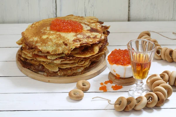 Pancakes with red caviar and tincture in a glass. — Stock Photo, Image
