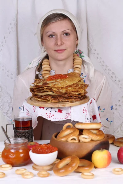 Girl eating pancakes with caviar