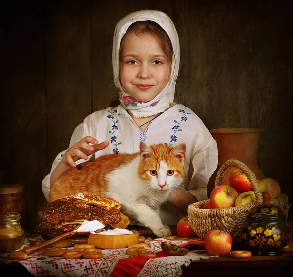 Flickan med den röda katten för semestern bordet — Stockfoto