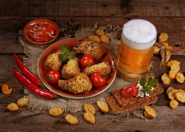 Beer in a clear mug and chicken nuggets with ketchup — Stock Photo, Image