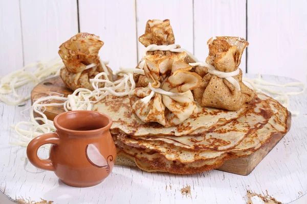 Pancake bags with meat on a white wooden background — Stock Photo, Image