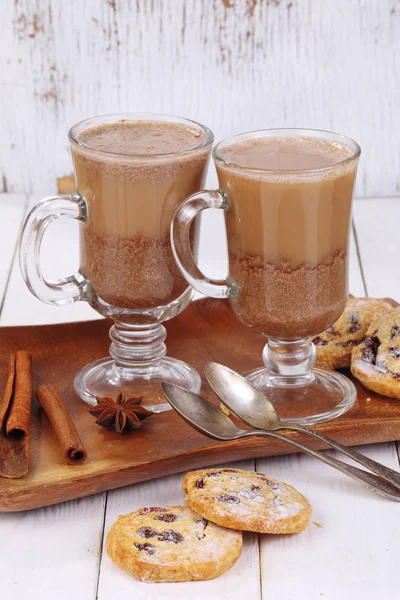 Cocoa with cinnamon and cookies on wooden background — Stock Photo, Image