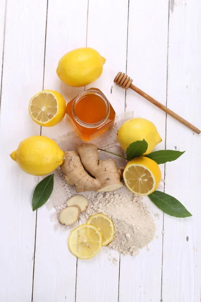 Лимон з медом та імбиром на білому дерев'яному фоні — стокове фото