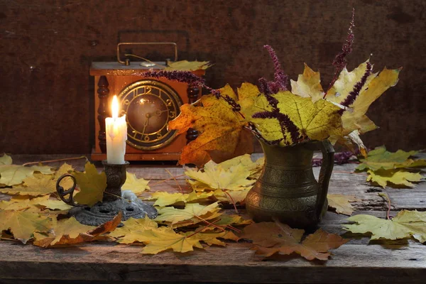 Vinho tinto, livros, tinta e uma vela acesa em uma mesa de madeira — Fotografia de Stock