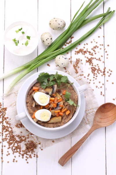 Porridge with mushrooms and quail eggs — Stock Photo, Image