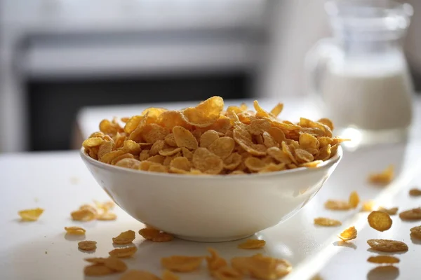 Cornflakes with milk for breakfast. Cornflakes in a plate on the table