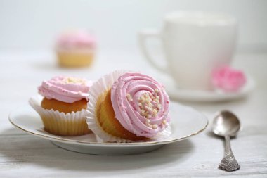 Beyaz arka planda kremalı kekler.