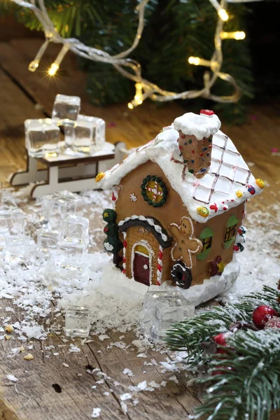 Gingerbread house in the snow against the background of a garland