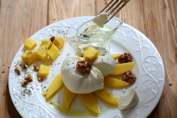 Cheese with mango, walnut and honey — Stock Image Cheese Mango Walnut Honey Royalty Free Stock Images