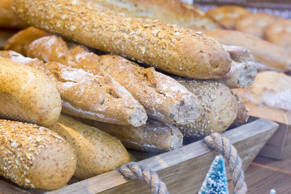 Loaves of integral bread in a wooden box.