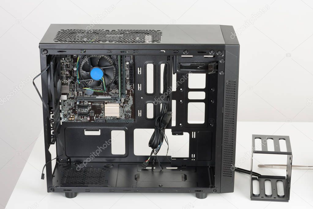 Building of PC, ATX motherboard inserted to black computer midi 