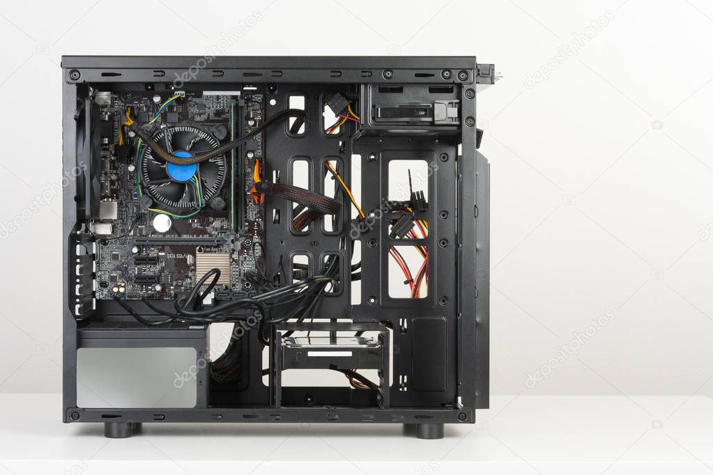 Building of PC, ATX motherboard inserted to black computer midi 