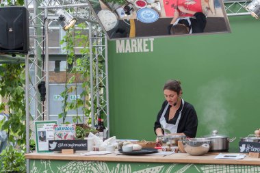 SOUTHWARK, LONDON-SEPTEMBER 7,2017: Olia Hercules is cooking in stall at Borough Market on September 7, 2017 in London. Olia Hercules is a London-based chef, recipe writer and food stylist.  clipart