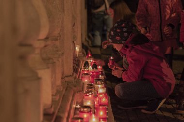 Velvet Devrimi kutlamalarında çocuk mum yakıyor.