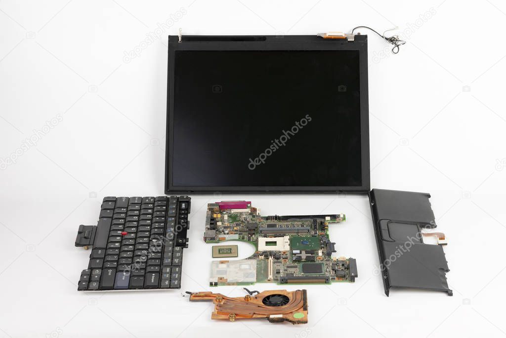 Disassembled laptop, basic components of notebook, screen,  keyboard, processor,  motherboard, touchpad , CPU fan. 