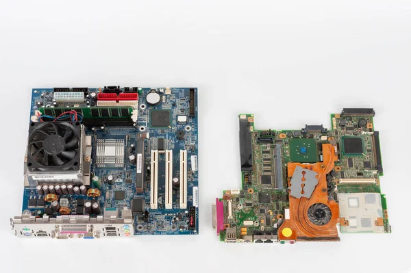 Comparing two mother boards  with fans, one from desktop PC and one with orange fan from laptop