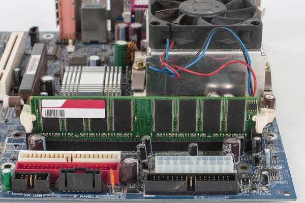 Main board of old desktop computer, close up of  memory module in slot on motherboard.