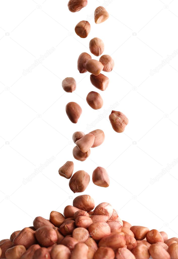 Some peanut peeled falling on white background.