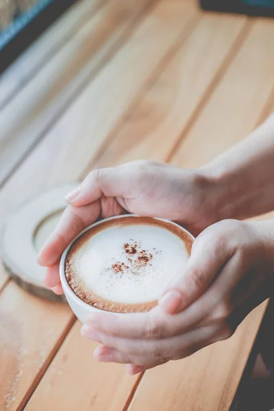 Frau hält eine Tasse Kaffee in der Hand mit Vintage-Farbton Filterhintergrund — Stockfoto