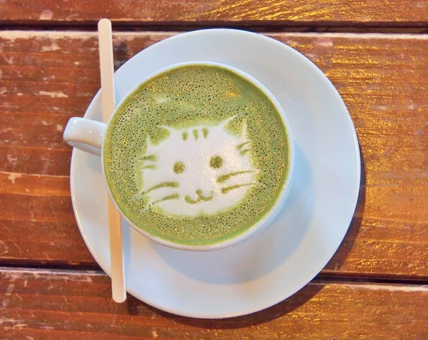 Matcha green tea latte with latte art 'Cat face'