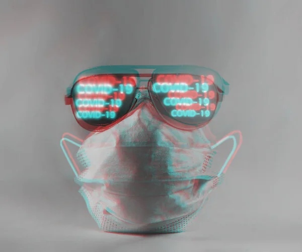 Medical protective disposable mask and glasses with inscription COVID-19. Creative modern concept. Image with anaglyph stereo effect.