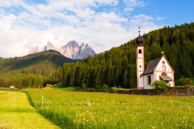 Santa Maddalena church in Val di Funes valley clipart
