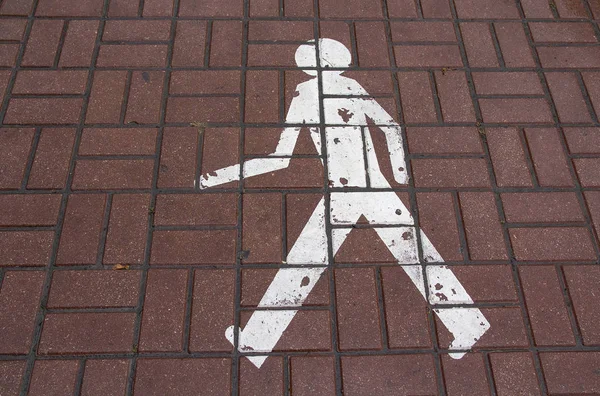 Traffic sign in the form of a painted man. City — Stock Photo, Image