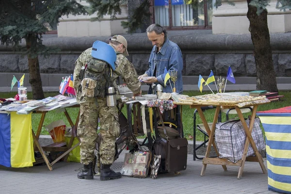 Киев, Украина - 18 сентября 2015 года: Солдат в форме покупает сувениры на Площади Независимости — стоковое фото