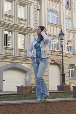 Bir ev bir arka plan üzerinde beyaz bir ceketi giyen güzel bir kadın. İnsanlar