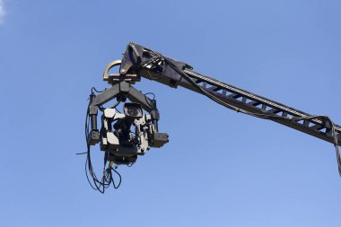 Professional camera on the crane against the sky clipart