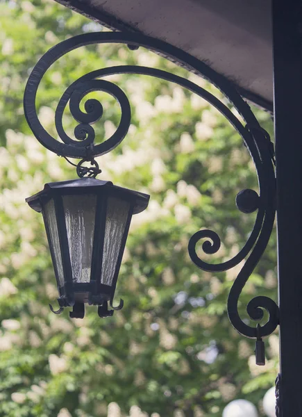 Old retro lantern forged from metal. City — Stock Photo, Image